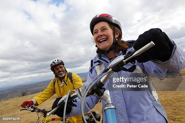 older couple on bikes - couple cycling stock pictures, royalty-free photos & images
