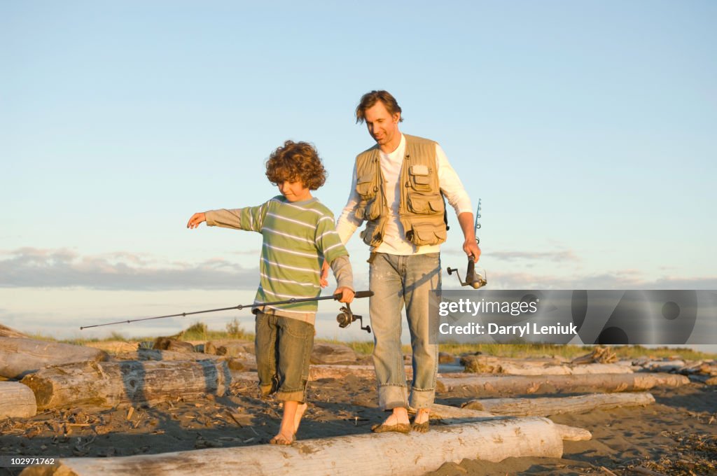 Father Log Father And Son Walking On Log On Beach High-Res Stock Photo - Getty Images