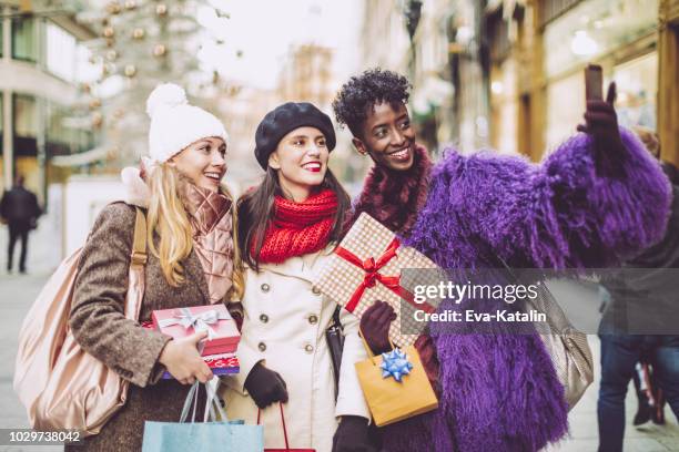 friends are taking a selfies with christmas presents - street style winter stock pictures, royalty-free photos & images