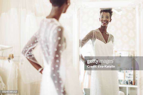 the bride is checking out her wedding dress - bride getting dressed stock pictures, royalty-free photos & images