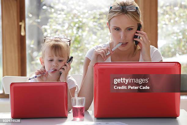 daughter copy mother working on laptop - child wearing adult glasses stock pictures, royalty-free photos & images