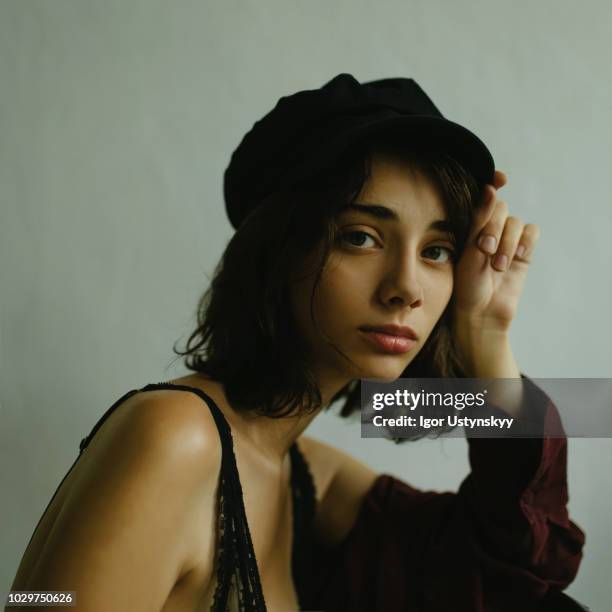 young woman posing in studio - flat cap stock pictures, royalty-free photos & images