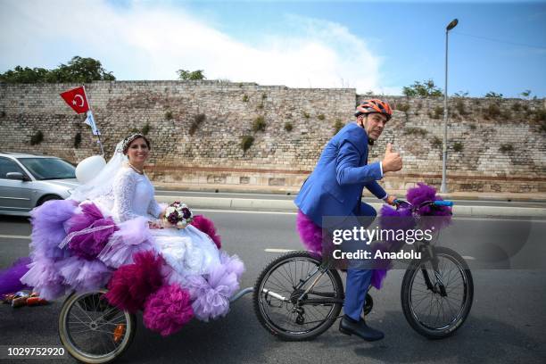 Bridal couple are seen on a wedding convoy at Sarayburnu coast riding a wedding vehicle made by a bicycle in Istanbul, Turkey on September 09, 2018.