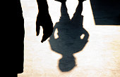 Blurry shadow silhouette of two boys confronting each other