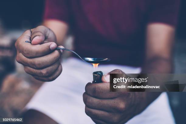 preparing his dose - heroin addict arm stock pictures, royalty-free photos & images