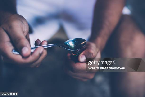 preparing his dose - heroin addict arm stock pictures, royalty-free photos & images