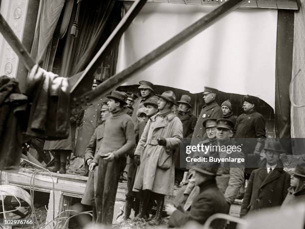 Policeman, rescue workers, and onlookers stand on and near the stage amid the wreckage of the Knickerbocker Theatre, Washington DC, January 29, 1922....