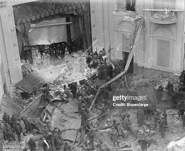 Policeman, rescue workers, and onlookers stand amid the wreckage of the Knickerbocker Theatre, Washington DC, January 29, 1922. The structure's roof...