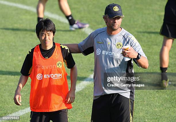 Head coach Juergen Klopp embraces Shinji Kagawa during the Borussia Dortmund Training Camp for the upcoming season 2010/2011 on July 19, 2010 in...