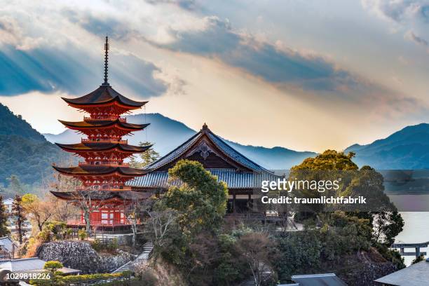 red shinto pagoda on miyajima - japan stock pictures, royalty-free photos & images