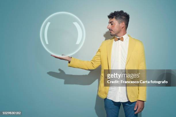 man with crystal ball - gelber anzug stock-fotos und bilder