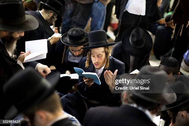 Religious Jews pray at the Western Wall in Jerusalem's Old City during the annual 9th of Av memorial for the destruction of ancient Jerusalem on July...