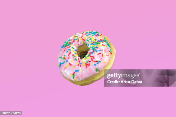 pink donuts with colorful toppings. - zero gravity food stock pictures, royalty-free photos & images