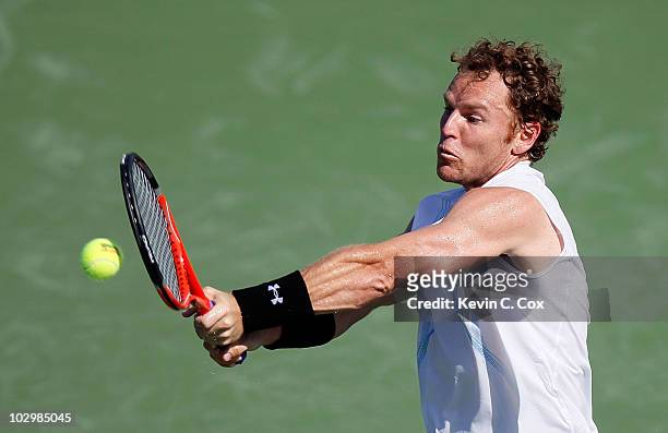 Michael Russell returns a backhand to Benjamin Becker of Germany on Day 1 of the Atlanta Tennis Championships at the Atlanta Athletic Club on July...