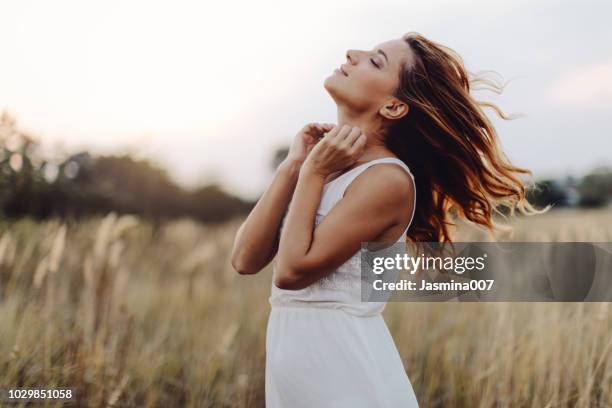 young woman outdoor enjoying the sunset - air serbia stock pictures, royalty-free photos & images