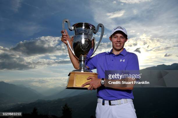 Matthew Fitzpatrick of England celebrate with the trophy after winning The Omega European Masters at Crans-sur-Sierre Golf Club on September 9, 2018...