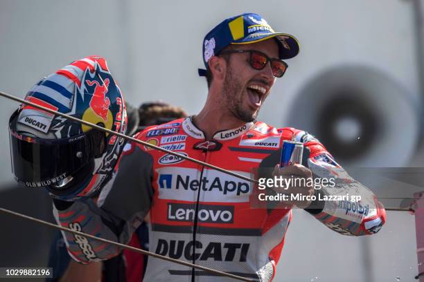 Andrea Dovizioso of Italy and Ducati Team celebrates the victory on the podium at the end of the MotoGP race during the MotoGP of San Marino - Race...