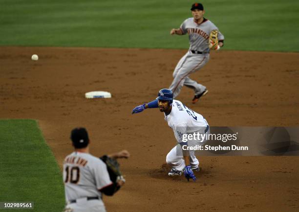 Matt Kemp of the Los Angeles Dodgers is caught in a rundown between first baseman Travis Ishikawa and second baseman Freddy Sanchez of the San...