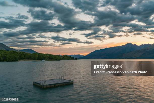 lake wakatipu at sunset, new zealand. - floating platform stock pictures, royalty-free photos & images