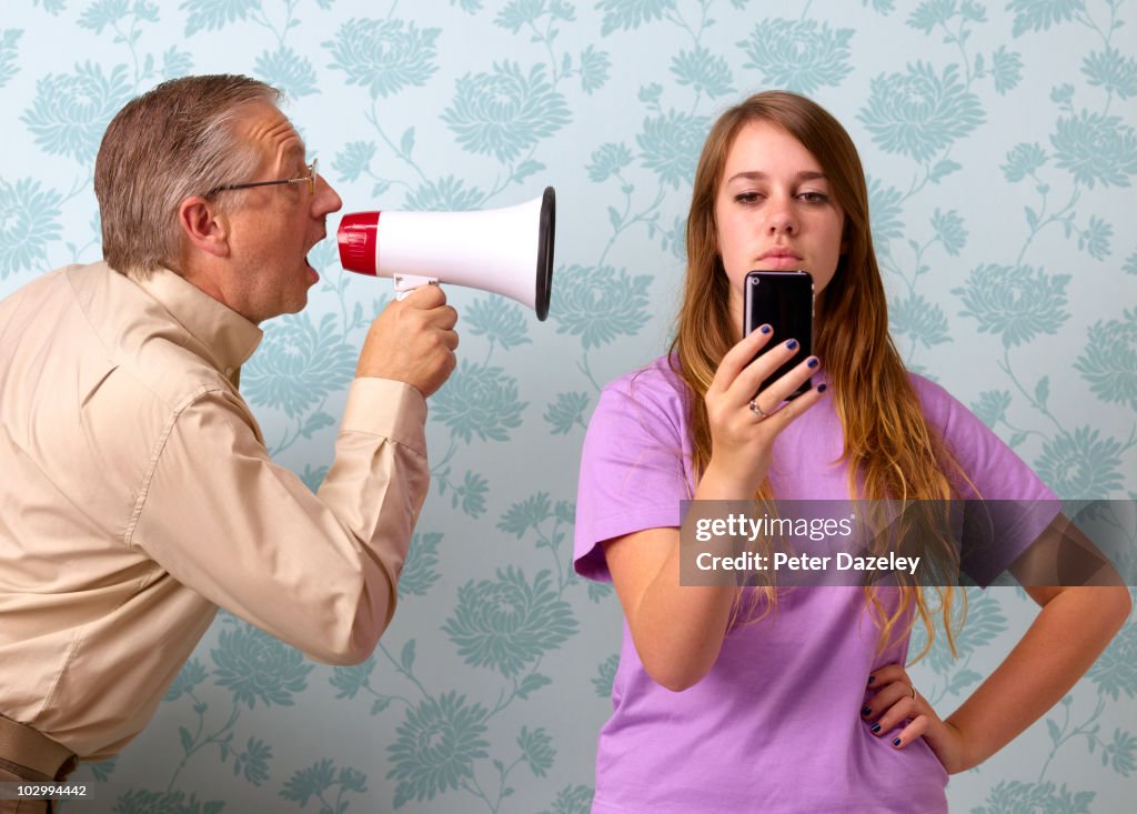 Father shouting at daughter texting