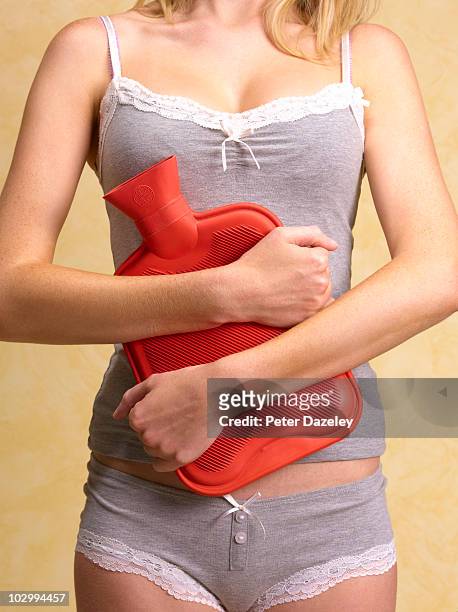 28 year old woman with stomach ache period pain - pms stock pictures, royalty-free photos & images