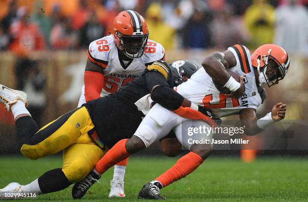 Tyrod Taylor of the Cleveland Browns is tackled by Cameron Heyward of the Pittsburgh Steelers during the second quarter at FirstEnergy Stadium on...