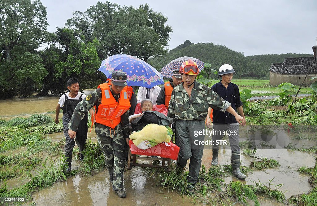 Paramilitary police carry an elderly Chi