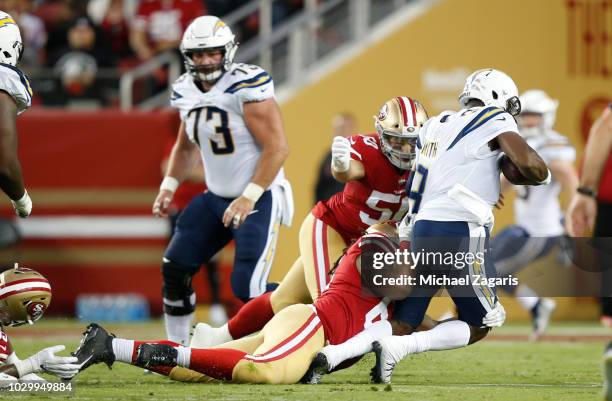 Will Sutton and Brock Coyle of the San Francisco 49ers sack Geno Smith of the Los Angeles Chargers during the game at Levi Stadium on August 30, 2018...