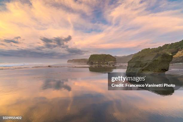three sisters beach at sunset, new zealand. - new plymouth stock pictures, royalty-free photos & images