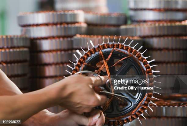 electric motor production by china factory worker - elektrische motor stockfoto's en -beelden