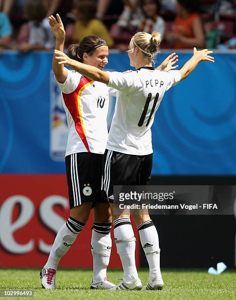 Alexandra Popp of Germany celebrates scoring the third goal with Dzsenifer Marozsan during the FIFA U20 Women's World Cup Group A match between...