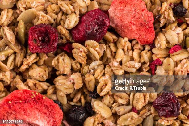 muesli cereals close up background with  raisins, oat and wheat flakes, fruits, strawberry, cranberry, cherry pieces - クランベリー ストックフォトと画像