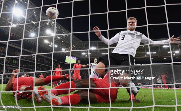 Julian Brandt of Germany scores his team's first goal past Anderson Santamaria of Peru and Luis Advincula of Peru challenged by Timo Werner of...