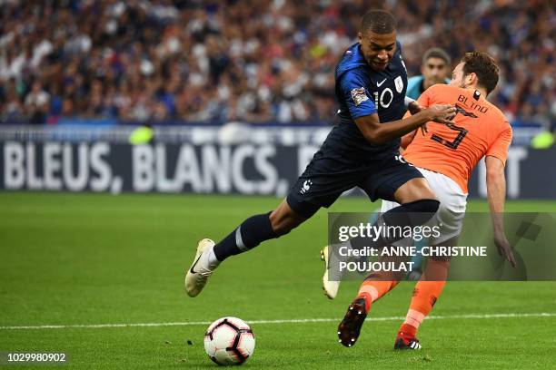 France's midfielder Kylian Mbappe vies for the ball with Netherlands' defender Daley Blind during the UEFA Nations League football match between...