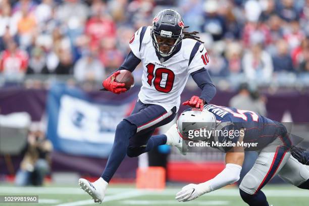 Kyle Van Noy of the New England Patriots tackles DeAndre Hopkins of the Houston Texans during the second half at Gillette Stadium on September 9,...