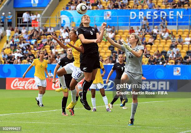 Bridgette Armstrong of New Zealand and Ludmila of Brazil jump for a header during the 2010 FIFA Women's World Cup Group B match between New Zealand...