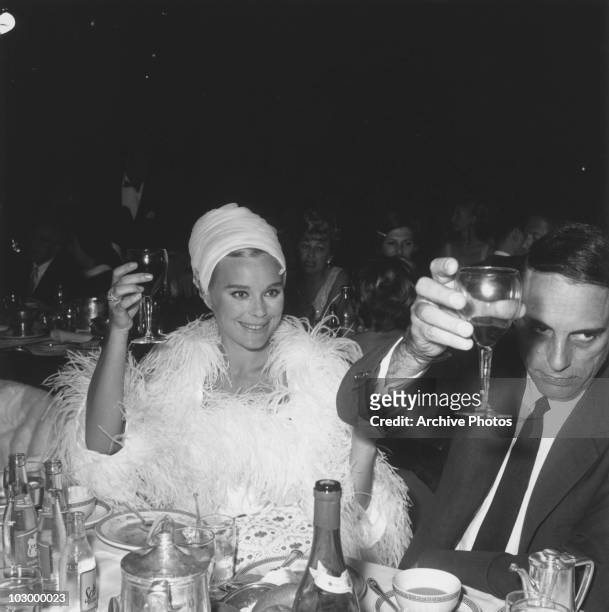 German actress Elke Sommer and her husband Joe Hyams raise their glasses at Tony Bennett's opening night at the Cocoanut Grove, May 10, 1966.