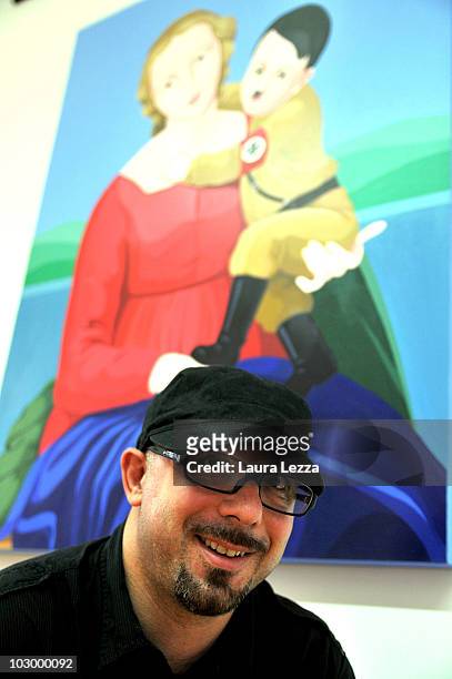 Italian painter Giuseppe Veneziano poses next to his painting "La Madonna del terzo Reich" at Palazzo Panichi which is staging his latest major...