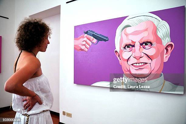 Visitor views the painting "Under attack" by italian artist Giuseppe Veneziano at Palazzo Panichi which is staging his latest major exhibition...