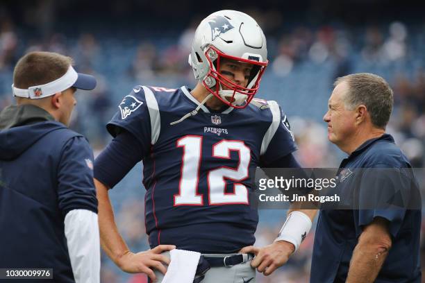 Tom Brady of the New England Patriots talks with offensive coordinator Josh McDaniels and head coach Bill Belichick before the game against the...