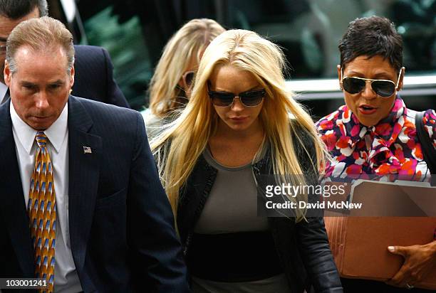 Actress Lindsay Lohan and lawyer Shawn Chapman Holley arrive at the Beverly Hills Courthouse to surrender to serve her 90 day jail sentence on July...