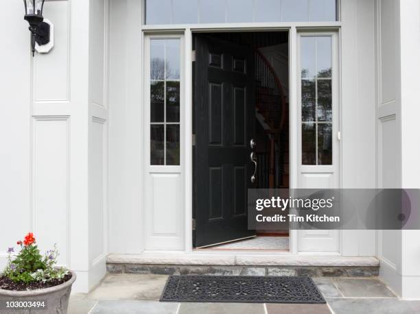 front porch of house with front door open - entrance building stock-fotos und bilder