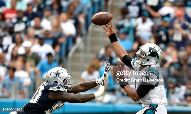 Cam Newton of the Carolina Panthers passes over Demarcus Lawrence of the Dallas Cowboys in the third quarter during their game at Bank of America...