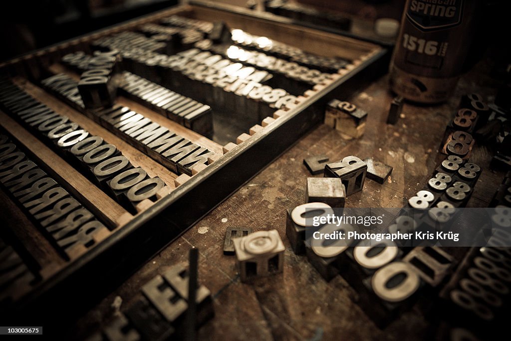 Metal Letter Blocks Scattered on Wooden Table
