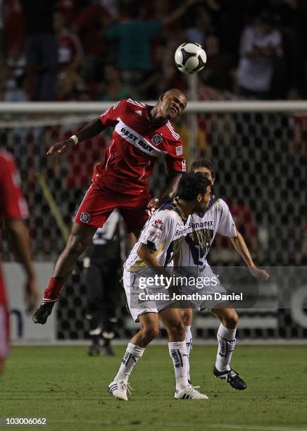 Collins John of the Chicago Fire leaps over Jehu Chiapas of Pumas UNAM for a header during a SuperLiga 2010 match at Toyota Park on July 20, 2010 in...