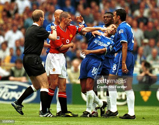 Referee M.Riley steps in to stop a tussel between Roy Keane of Manchester United and Roberto Di Matteo of Chelsea before giving Roy Keane a red card...