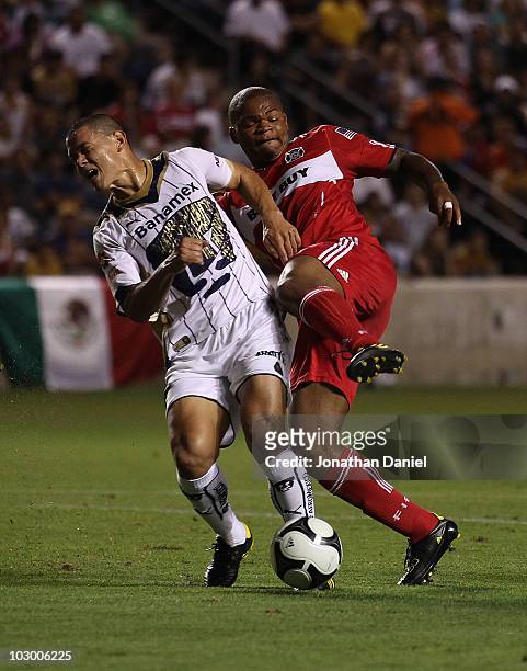 Collins John of the Chicago Fire collides with Dario Veron of Pumas UNAM during a SuperLiga 2010 match at Toyota Park on July 20, 2010 in Bridgeview,...