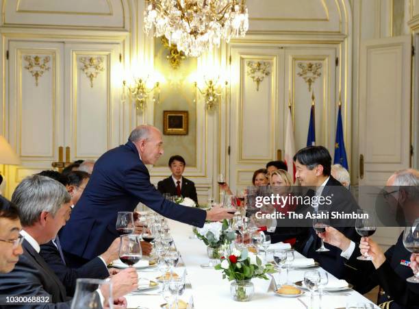 Crown Prince Naruhito of Japan and French Interior Minister Gerard Collomb toast glasses during their dinner on September 8, 2018 in Lyon, France.