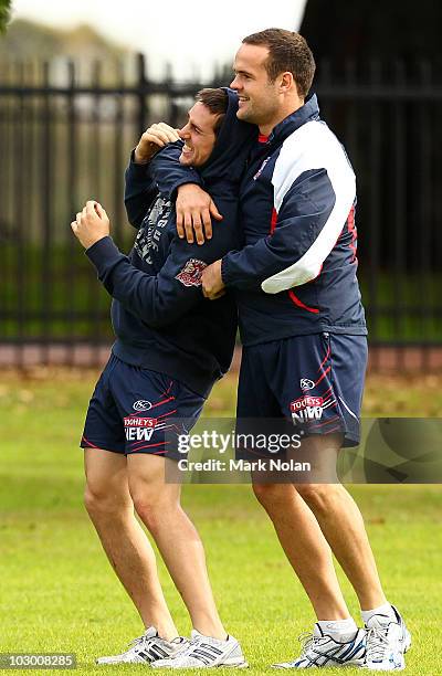 Mitchell Pearce and Nate Myles wrestle during a Sydney Swans AFL training session at the Sydney Cricket Ground on July 21, 2010 in Sydney, Australia.