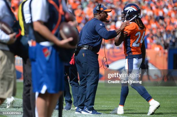 Head coach Vance Joseph talks with Adam Jones of the Denver Broncos during a game against the Seattle Seahawks at Broncos Stadium at Mile High on...